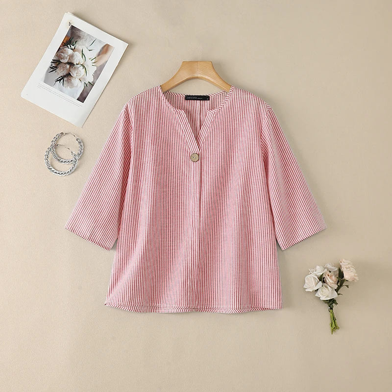 Pink striped V-neck roll sleeve blouse flat lay.