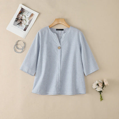 Blue striped V-neck roll sleeve blouse flat lay.