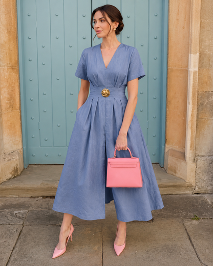 Woman wearing a blue V-neck belted midi dress with a flattering waist belt.