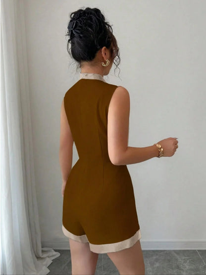 Woman wearing the Celina Studio Brown & Ivory Contrast Trim Sleeveless Romper featuring a modern high neckline, elegant contrast trim, fitted silhouette, and tailored shorts.