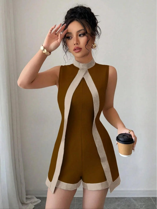 Woman wearing the Celina Studio Brown & Ivory Contrast Trim Sleeveless Romper featuring a modern high neckline, elegant contrast trim, fitted silhouette, and tailored shorts.