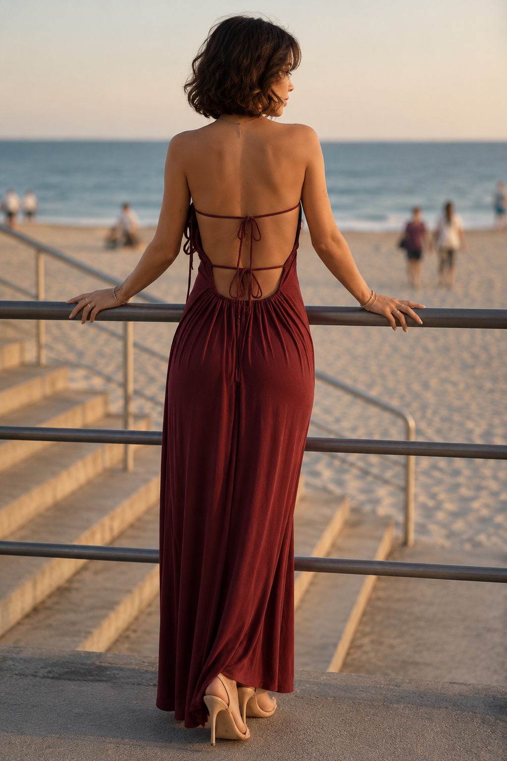 Back view of a burgundy smocked cami maxi dress with adjustable spaghetti straps.