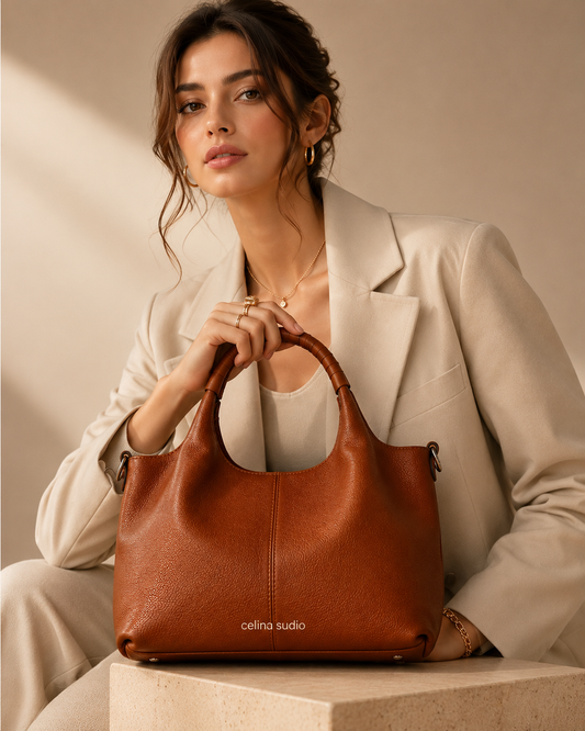 Woman carrying a caramel soft leather shoulder tote bag.