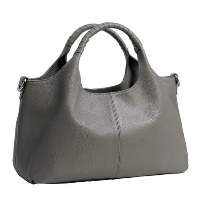 Woman carrying a charcoal gray soft leather shoulder tote bag.