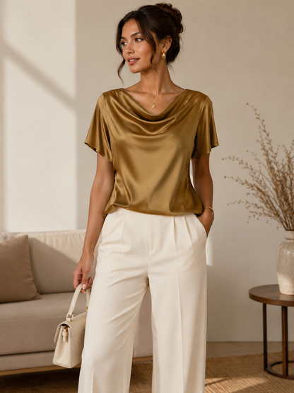 Woman wearing the Celina Studio Élan Drape Satin Blouse in Caramel Mocha.