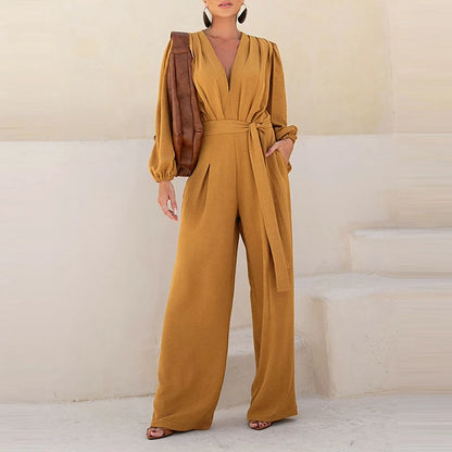 Woman wearing the Celina Studio Élan Wrap Wide-Leg Jumpsuit in Caramel Mocha with elegant long sleeves.