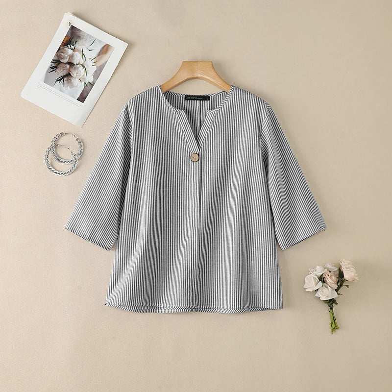 Gray striped V-neck roll sleeve blouse flat lay.