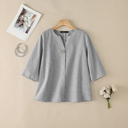 Gray striped V-neck roll sleeve blouse flat lay.