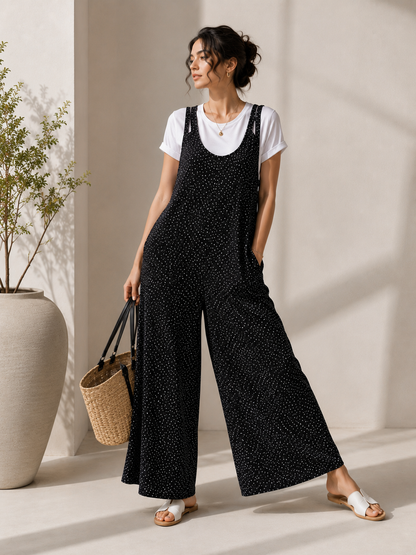 Woman wearing the Celina Studio Midnight Muse Wide-Leg Overall Jumpsuit in Black, front view.