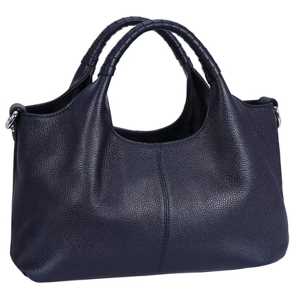 Woman carrying a navy blue soft leather shoulder tote bag.