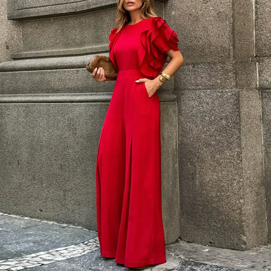 Woman wearing the Celina Studio Scarlett Ruffle Sleeve Wide-Leg Jumpsuit in Ruby Red, front view