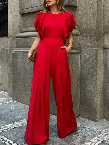 Side view of the Celina Studio Scarlett Ruffle Sleeve Wide-Leg Jumpsuit in Ruby Red.