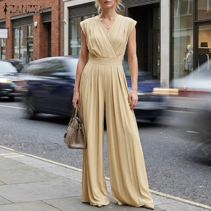 Woman wearing the Celina Studio Verona Drape Wide-Leg Jumpsuit in Champagne with a draped V-neckline and flowing wide-leg silhouette.
