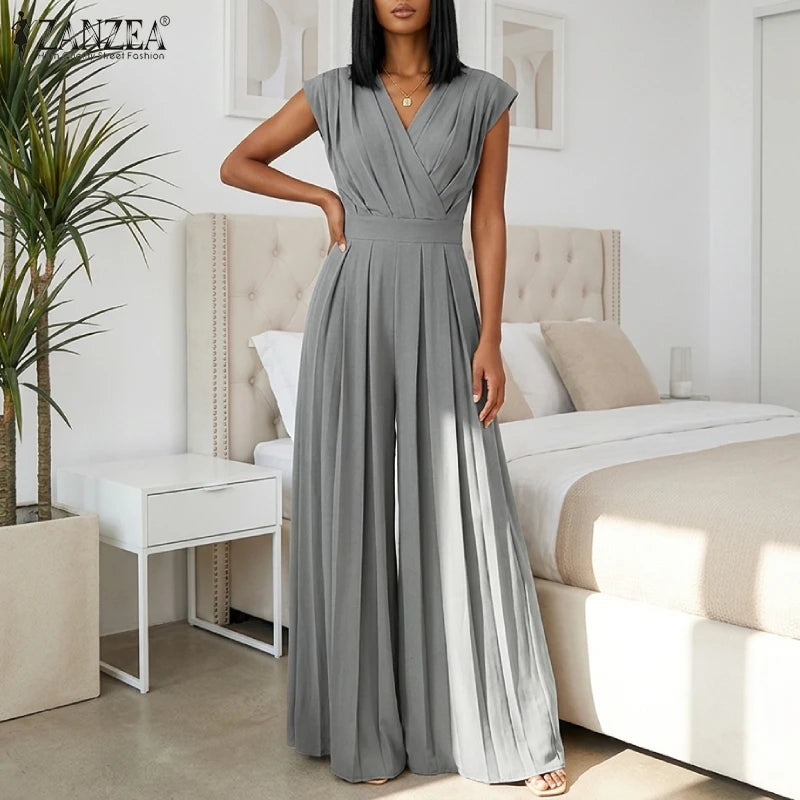 Woman wearing the Celina Studio Verona Drape Wide-Leg Jumpsuit in Slate Gray with a draped V-neckline and flowing wide-leg silhouette..