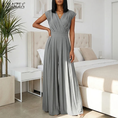 Woman wearing the Celina Studio Verona Drape Wide-Leg Jumpsuit in Slate Gray with a draped V-neckline and flowing wide-leg silhouette..