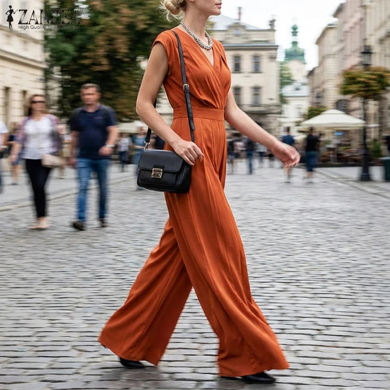 Woman wearing the Celina Studio Verona Drape Wide-Leg Jumpsuit in Rust with a draped V-neckline and flowing wide-leg silhouette.