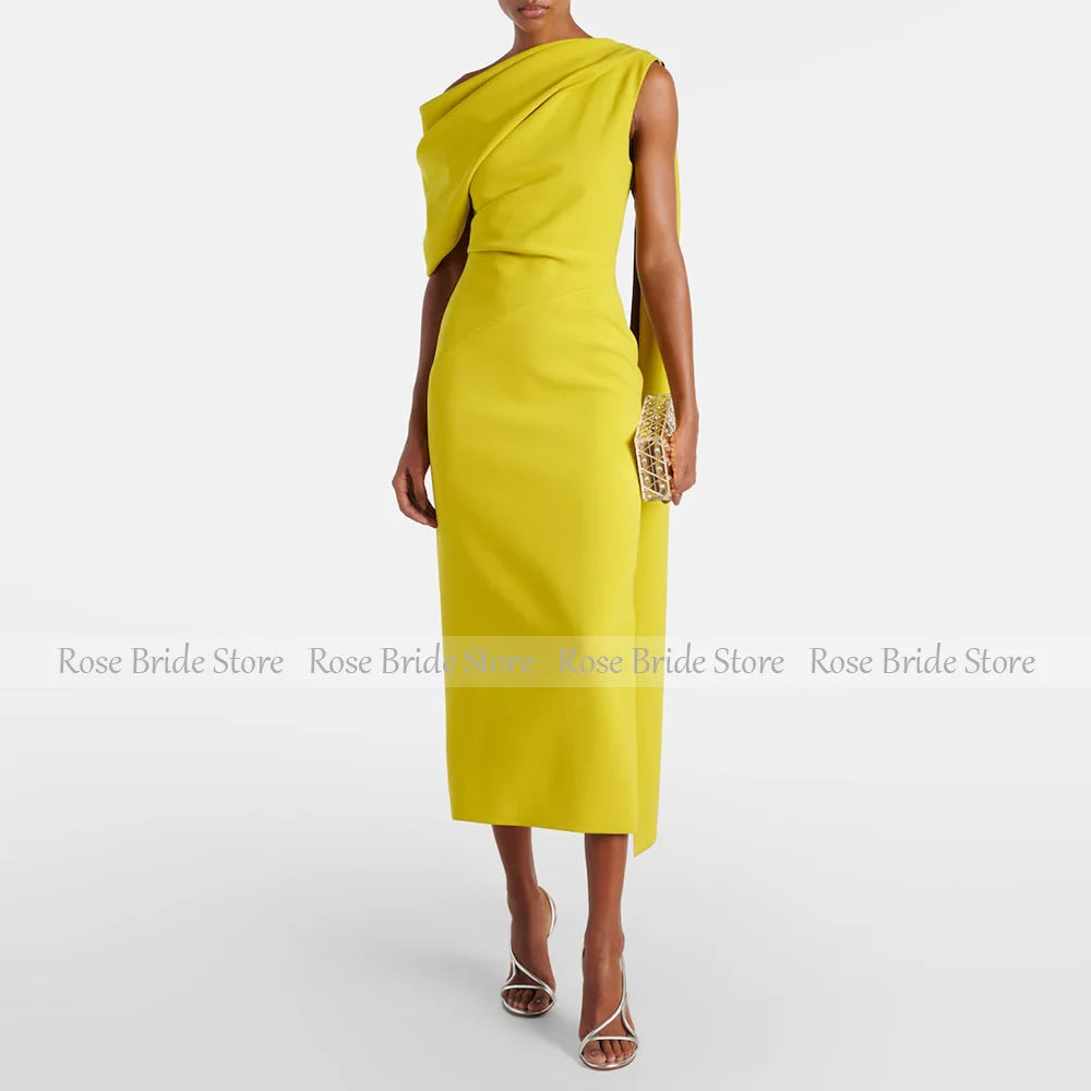 Woman wearing a yellow one-shoulder cape midi dress with a tailored silhouett