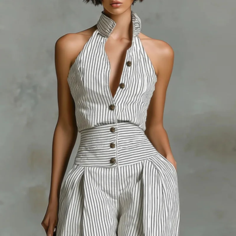 Woman wearing the Celina Studio Riviera Stripe Halter Wide-Leg Jumpsuit featuring a striped halter neckline, button-front detail, and a flowing wide-leg silhouette.