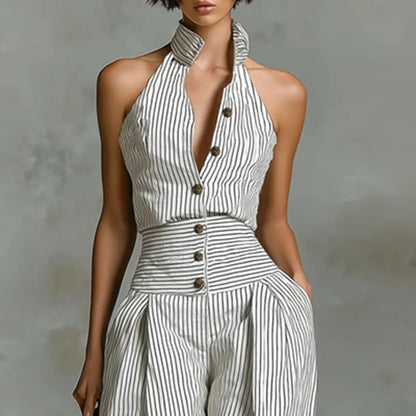 Woman wearing the Celina Studio Riviera Stripe Halter Wide-Leg Jumpsuit featuring a striped halter neckline, button-front detail, and a flowing wide-leg silhouette.